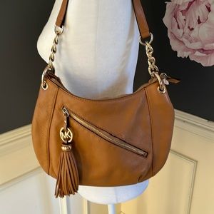 Michael Kors purse tan with gold detail.  Some stitching pulled on front pocket